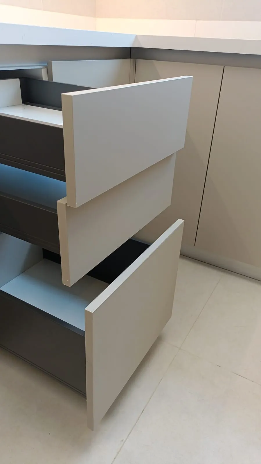 Cabinet alignment defect showing kitchen doors clashing and misaligned hinges found during snagging inspection in Dubai