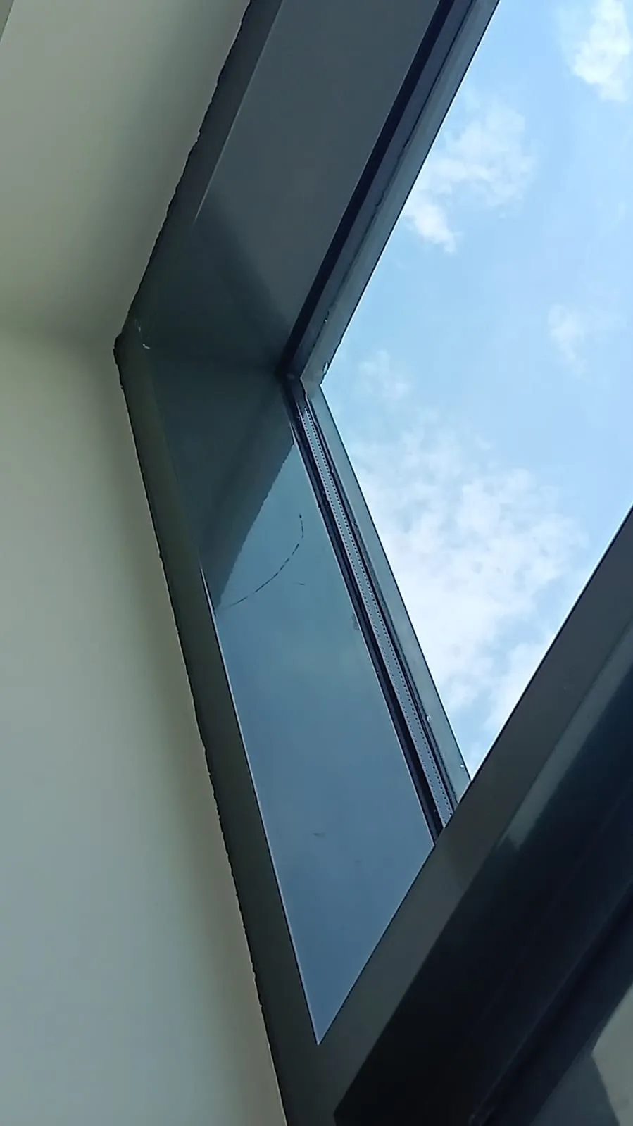 Scratched window glass and frame found during snagging inspection at a Mudon villa in Dubai